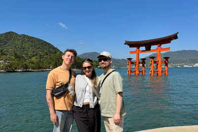 Travellers stood in front of the Itsukushima Shrine