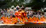 A group of travellers with Kung Fu practitioners in orange outfits