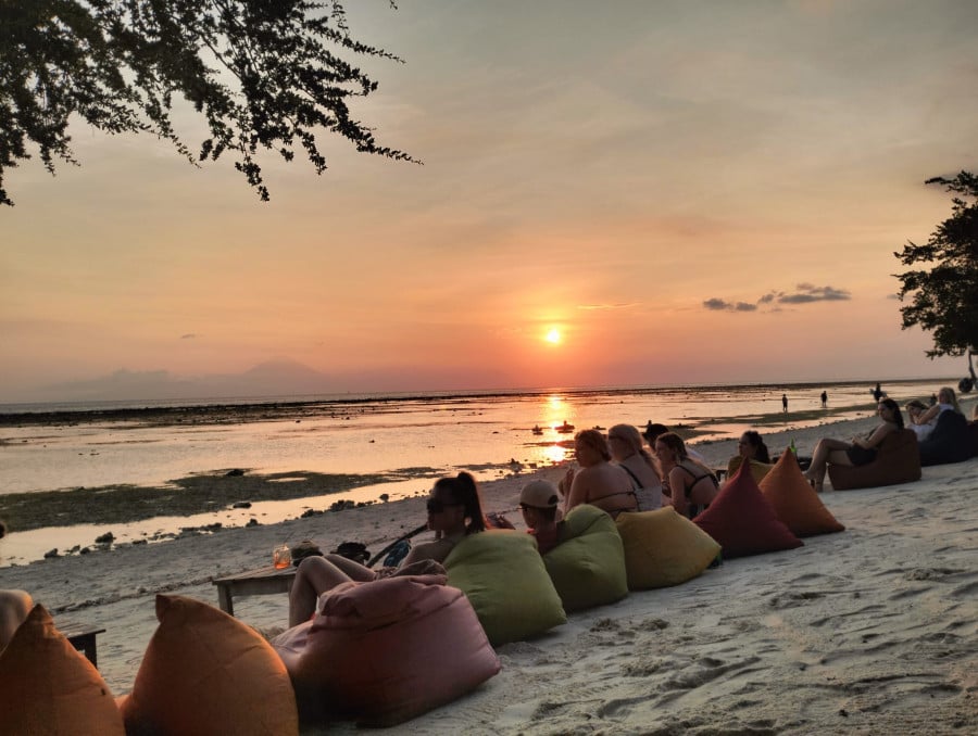 Group travellers on beach in Gili T Bali