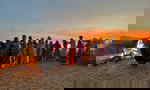 Travellers dancing in India at sunset