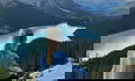 Traveller looking across Peyto Lake in Banff National Park in the Canadian Rockies