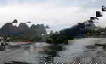People travelling down a river on wooden rafts
