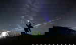 Traveller at camp site looking at the stars