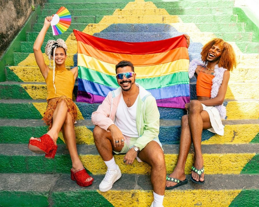 People holding up pride flag on steps in Brazil