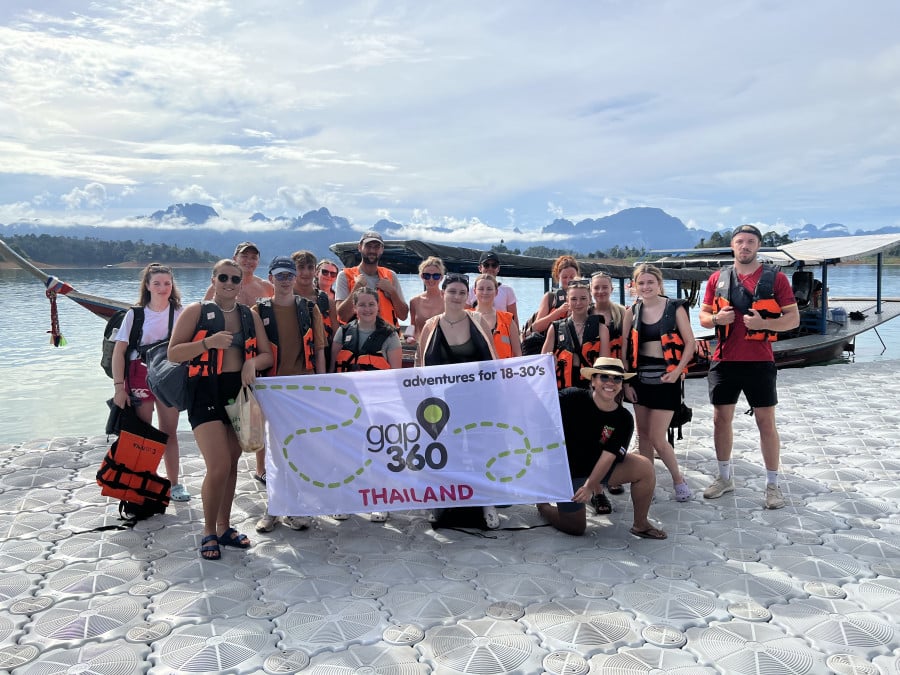 Travellers holding up a Gap 360 Thailand banner