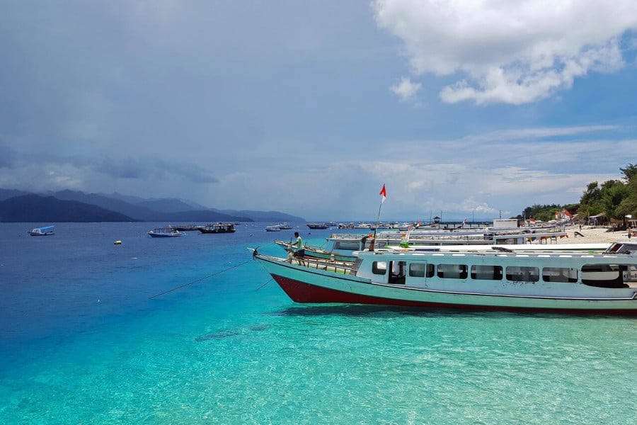 Boats on the shore of a beach in Gili Gede