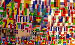 Country flags hanging from string above a street