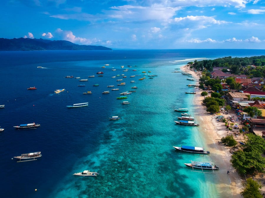 Looking over the beach in Gili Trawangan with boats parked up along the bay