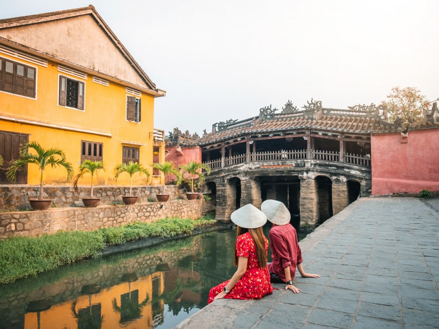 Couple sat near bridge in Hoi Vietnam