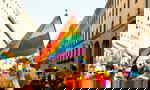 People with rainbow flags celebrating Pride in street in Europe