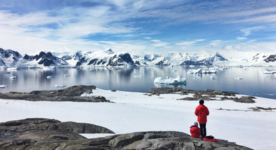 Group travellers near ice water in Antarctica