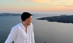 Traveller looking across Greek islands at sunset 
