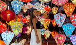 Traveller in front of colourful lanterns in Hoi An Vietnam