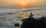 Traveller watching the sunset at Mirissa beach in Sri lanka